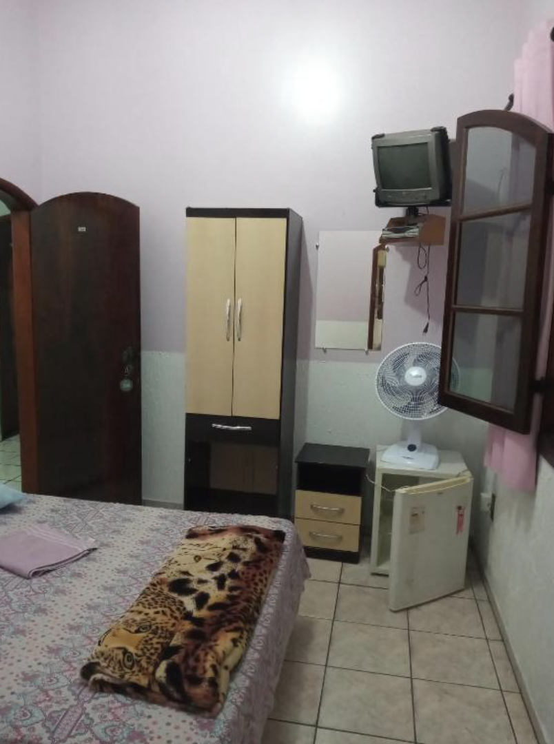 Quarto com armário, TV e ventilador
